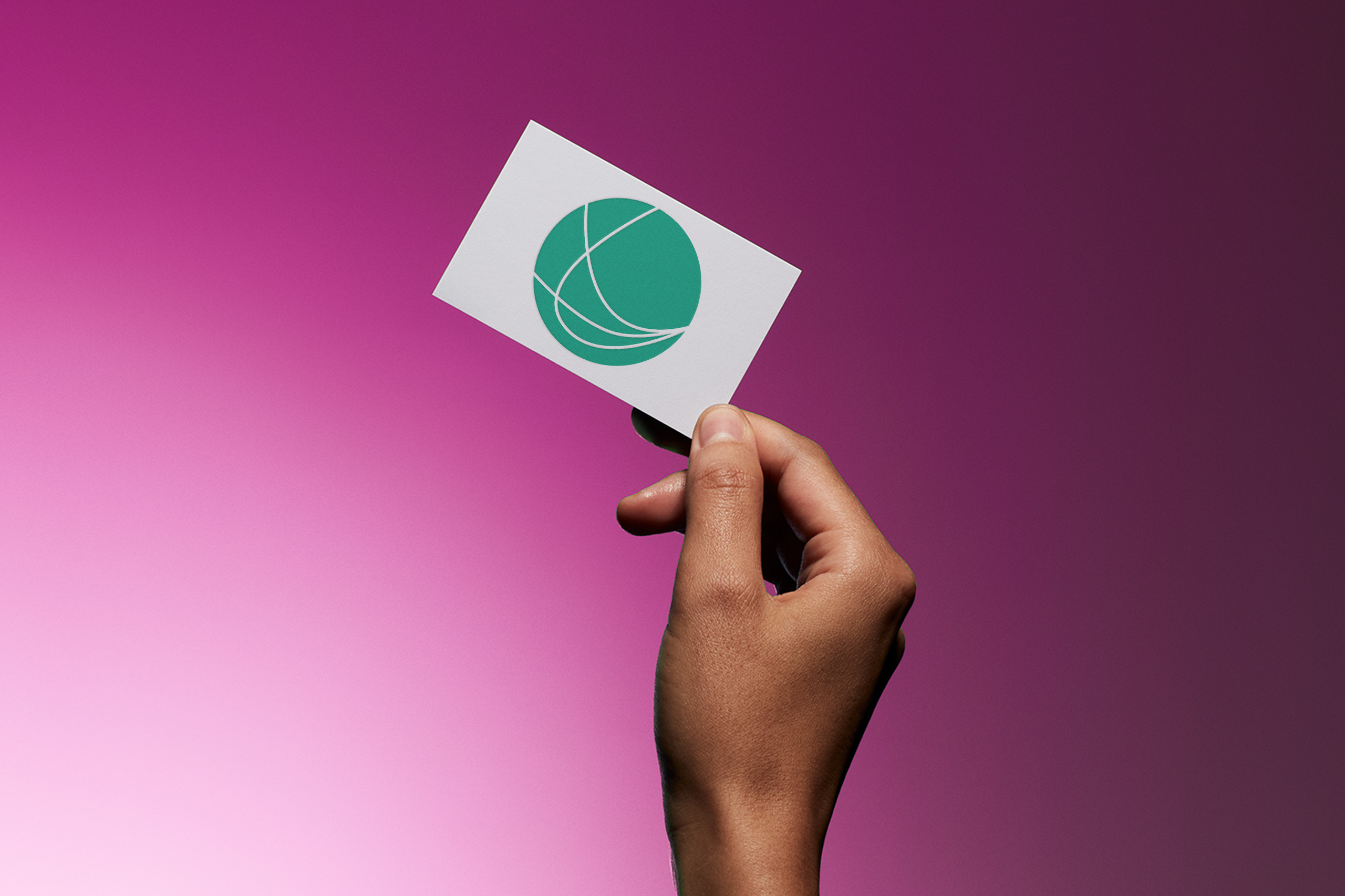 business card, hold by a hand,  with a green logo in the shape of a ball