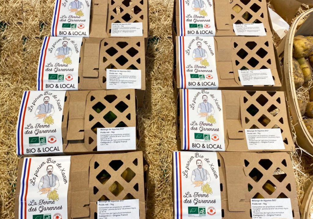 8 boxes made of carton with the label le panier bio de xavier, and an illustration of the farmer