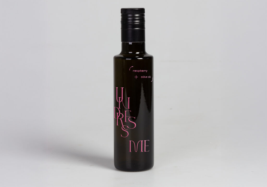 one bottle of vinegar without the label in the shape of a jacket, with as title undress me, printed in pink directly on the bottle