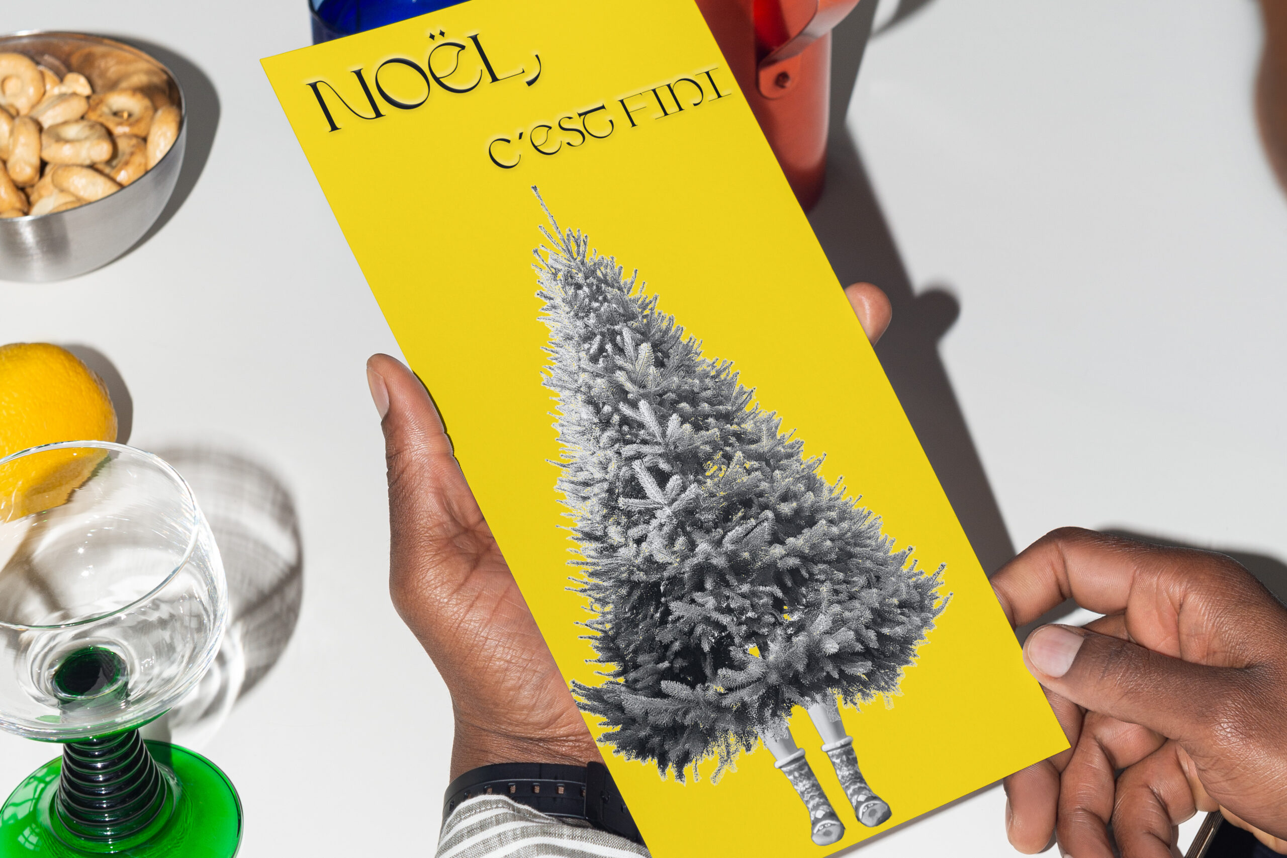 a yellow card hold in hands, announcing christmas is over